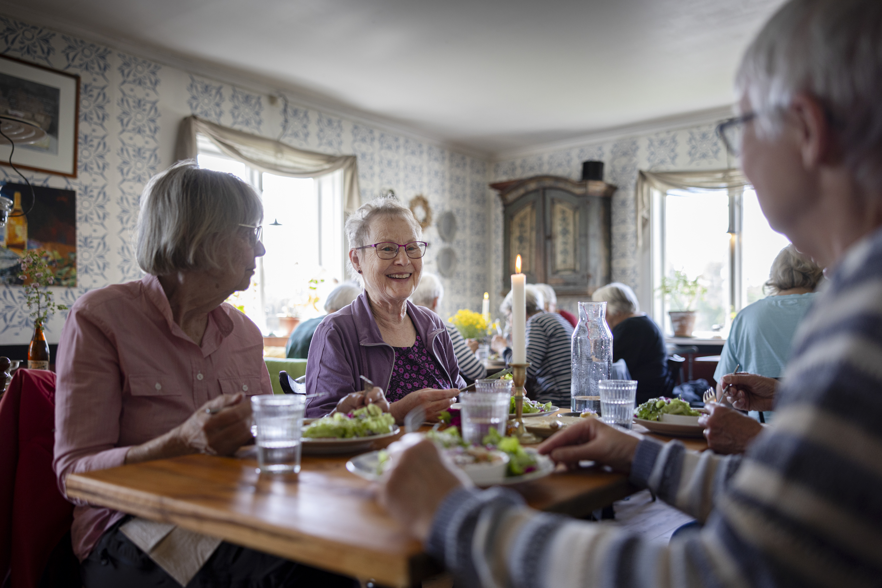 fyra äldre personer som äter middag på en restaurang